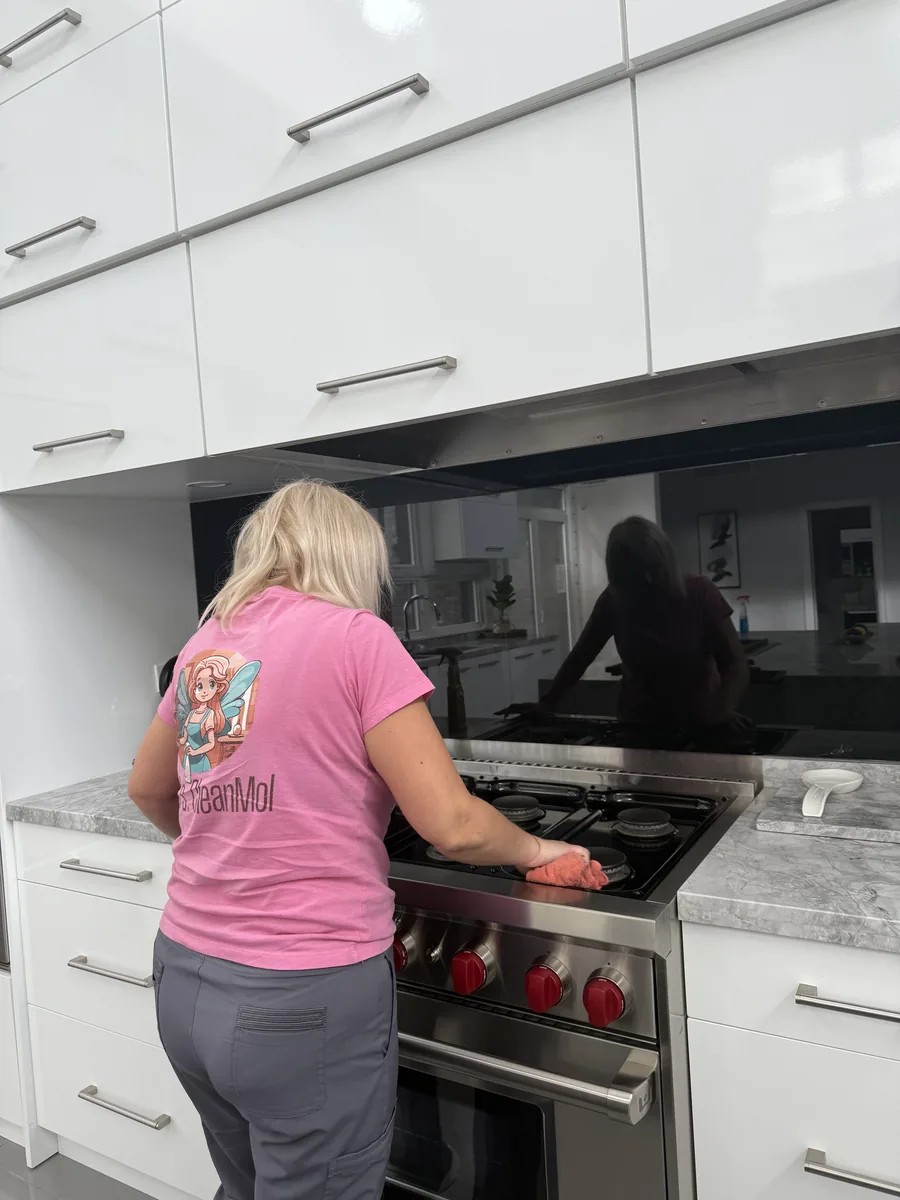 Mrs. CleanMol professional cleaner scrubbing kitchen stove - deep clean GTA