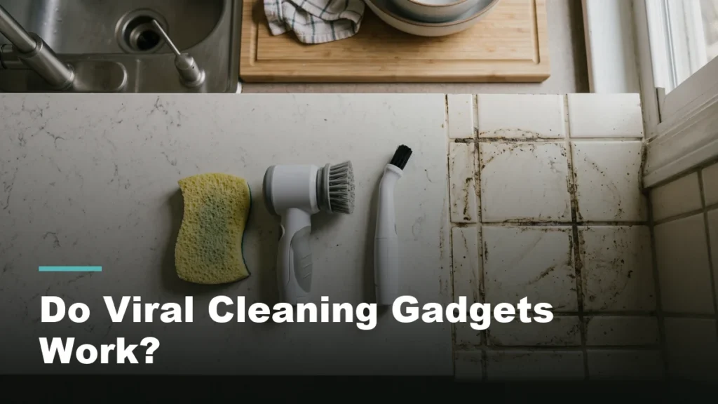 A lineup of handheld cleaning gadgets on a counter beside a section of dirty tile grout